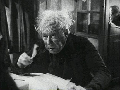 Seymour Hicks as Ebenezer Scrooge hears something go bump in the night in "Scrooge"